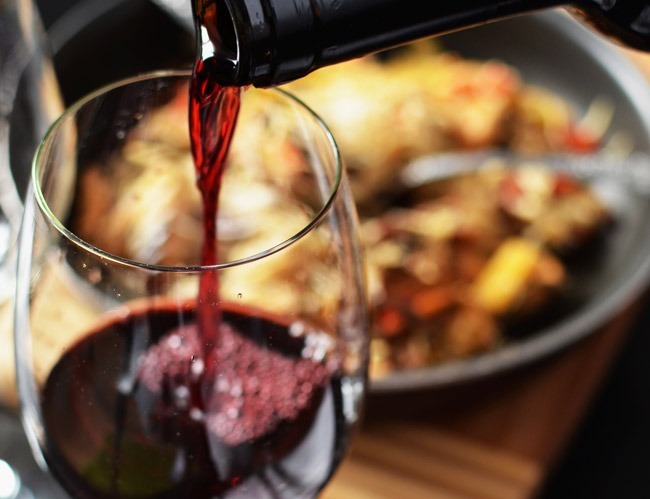 romantic-dinner-Cervasi Glass of red wine being poured